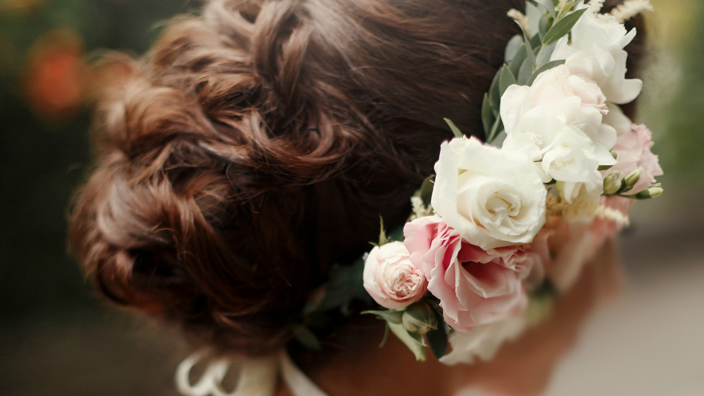 Woman In A Side Pose With Flowers Adorned In Her Tied Hair