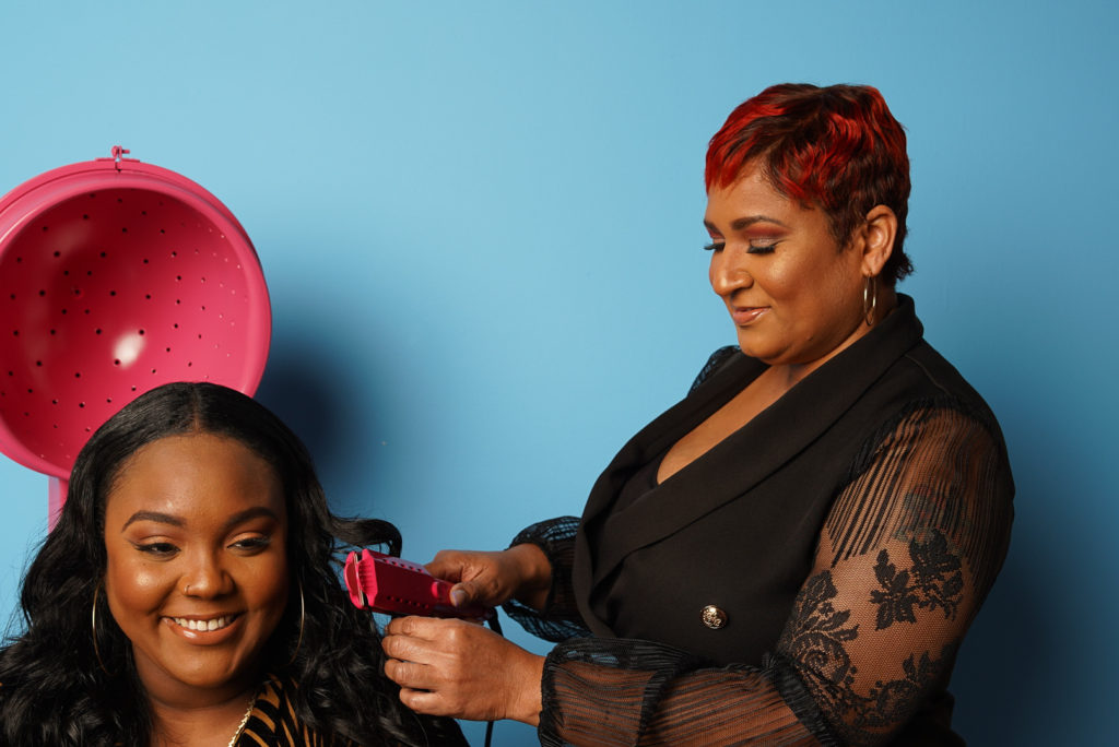 A Hair Stylist Curling Up Girl Hair