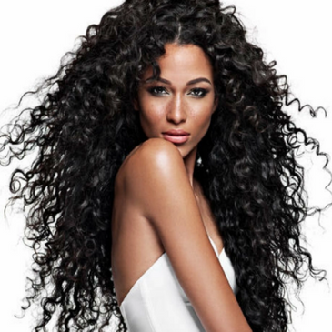 A Beautiful Woman Posing With Curly Black Hair Extensions Installed